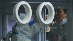 Residents line up to get their routine throat swab at a Covid-19 testing site in Beijing.