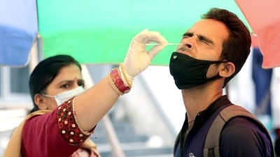 A healthcare worker collects a nasal swab sample of a man for Covid-19 testing, amid a recent surge in the coronavirus cases in India, in Jammu on Sunday. (ANI) A healthcare worker collects a nasal swab sample of a man for Covid-19 testing, amid a recent surge in the coronavirus cases in India, in Jammu on Sunday. (ANI)