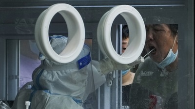 Residents line up to get their routine throat swab at a Covid-19 testing site in Beijing. (AP) Residents line up to get their routine throat swab at a Covid-19 testing site in Beijing. (AP)