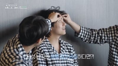 BTS' V laughs as Choi Woo-shik checks his eyes.