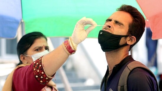 A health worker collects a nasal sample from a man for testing for Covid-19, amid a recent spike in coronavirus cases in India, in Jammu on Sunday.  (ANI)