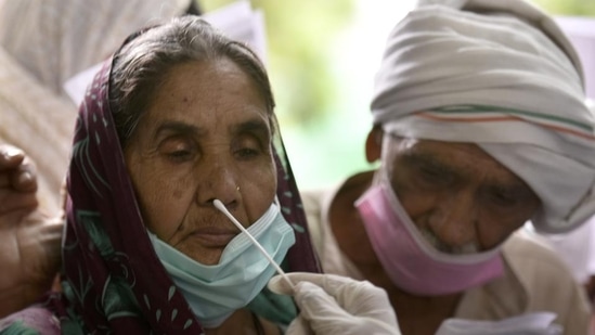 A healthcare worker collects a swab sample for a Covid-19 test at a district hospital&nbsp;(HT_PRINT)