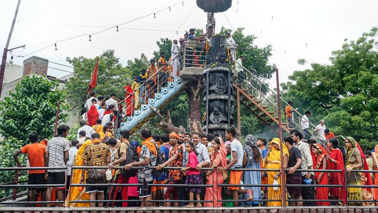 Devotees thronged Shiva temples around the country to perform ‘Jalabhishek (offer holy water to Shivalingam)’ of Lord Shiva as the Shivaratri of Sawan month is being celebrated after two years of the pandemic, while the police administration has made tight security arrangements.(PTI)