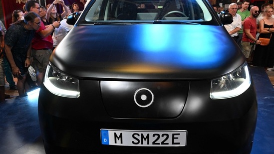 The Sion car, a solar electric vehicle (SEV) developed by Sono Motors, is surrounded by onlookers in Munich during the presentation of the final series production design.
