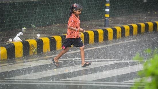 A child plays in the rain in New Delhi earlier this week. (PTI Photo)