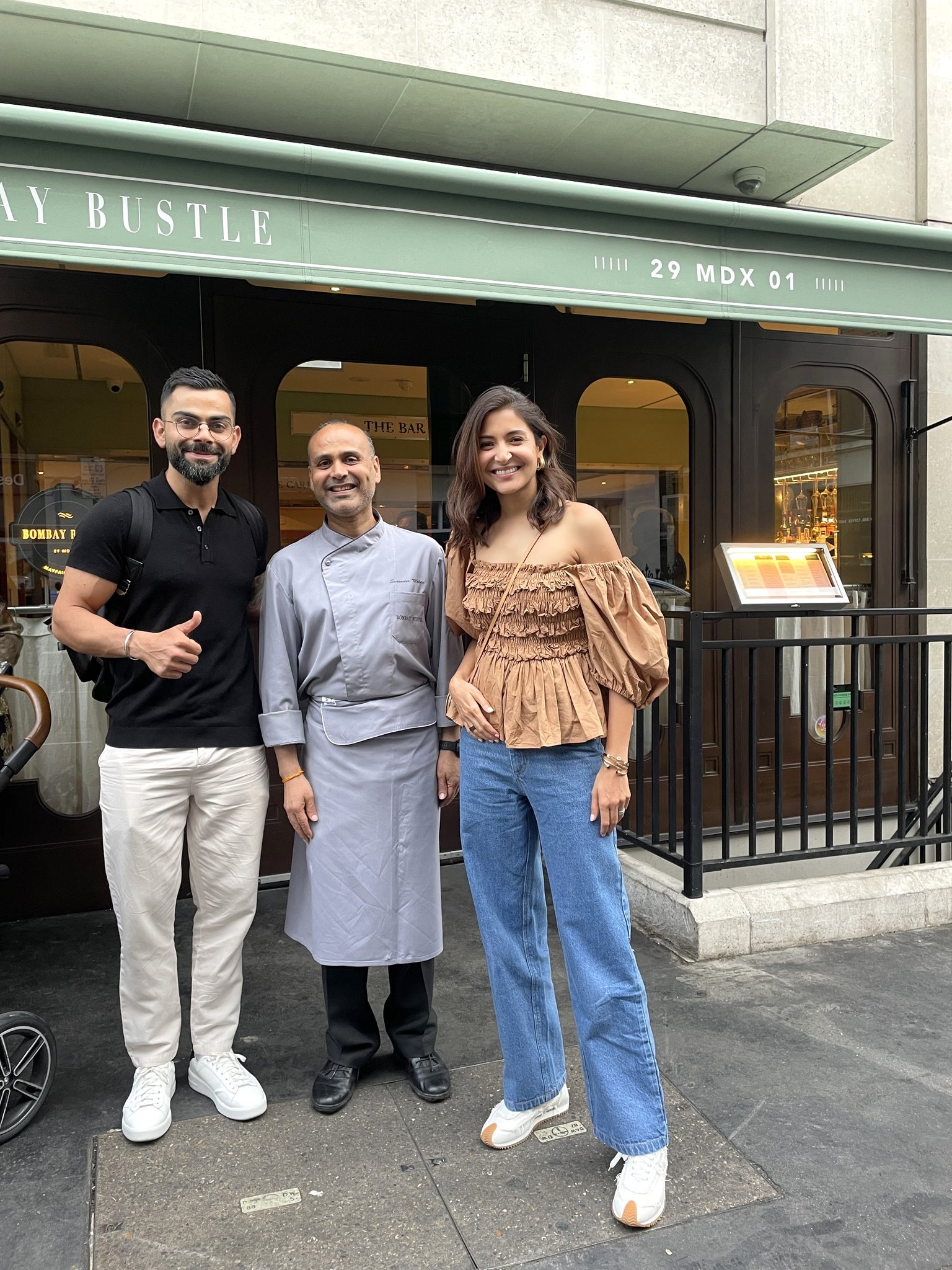 Anushka Sharma and Virat Kohli posing with a chef in London.