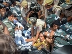 Delhi Police personnel detain Congress MP Jothimani Sennimalai.