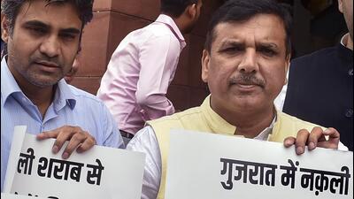 AAP MP Sanjay Singh during a protest against Gujarat hooch tragedy, at Parliament House in New Delhi, Wednesday. (PTI) AAP MP Sanjay Singh during a protest against Gujarat hooch tragedy, at Parliament House in New Delhi, Wednesday. (PTI)