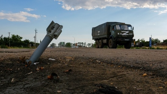 A Russian military truck drives past an unexploded munition during Ukraine-Russia conflict in the Russia-controlled village of Chornobaivka, Ukraine July 26, 2022. REUTERS/Alexander Ermochenko