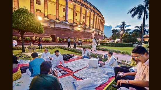 Opposition MPs who were suspended from the Rajya Sabha during a sit-in protest at Parliament House complex in New Delhi, on Wednesday. (PTI)