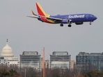 A Southwest Airlines aircraft flies past the US Capitol before landing at Reagan National Airport in Arlington, Virginia, US. US witnesses spike in airline bookings but travellers are not spending,&nbsp;