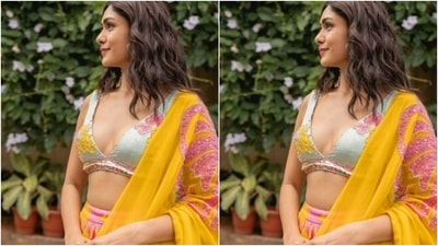 Mrunal decked up in a white satin blouse that featured a plunging neckline and a white zari lining. It also came embroidered in yellow and pink threads. (Instagram/@mrunalthakur)