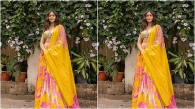Mrunal teamed her blouse with a contrasting bright yellow flowy skirt intricately printed in quirky patterns of pink. (Instagram/@mrunalthakur)