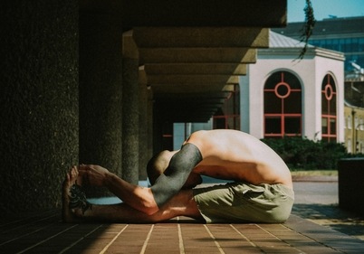 Paschimottanasana or seated forward-bend (Photo by Benn McGuinness on Unsplash)