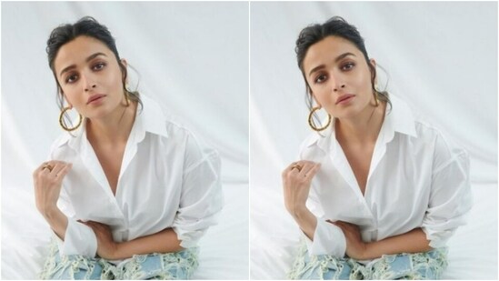 Styled by fashion stylist Ami Patel, Alia wore her tresses into a ponytail with a middle part, accessorised her look with golden hoop earrings and opted for minimal makeup in nude eyeshadow, black eyeliner, mascara-laden eyelashes, drawn eyebrows, contoured cheeks and a shade of nude lipstick.(Instagram/@aliaabhatt)
