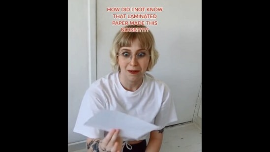 The image, taken from the Reddit video, shows the woman reacting to the rustling of a paper sheet. (Reddit/@SnooCupcakes8607)