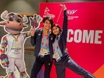 Boxers Lovlina Borgohain and Nikhat Zareen pose with 'Perry the Bull', the mascot of the Commonwealth Games 2022, in Birmingham, England.(PTI)