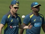 Australia's Adam Zampa, left, walks along with bowling coach Sridharan Sriram during a practice session.