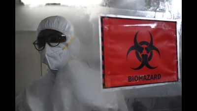 A technician wearing PPE walks past a biohazard sign inside a molecular laboratory facility set up to test for the monkeypox disease at the King Institute, Chennai, July 28, 2022 (AFP) A technician wearing PPE walks past a biohazard sign inside a molecular laboratory facility set up to test for the monkeypox disease at the King Institute, Chennai, July 28, 2022 (AFP)