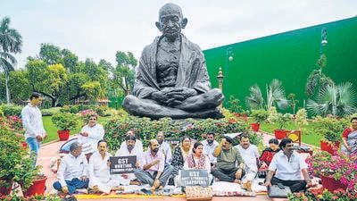 Suspended MPs sit during a protest against price hike and their suspension, at Parliament House in New Delhi on Friday. (AFP)