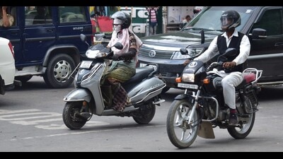 A woman riding a two-wheeler in Prayagraj. (HT photo) A woman riding a two-wheeler in Prayagraj. (HT photo)