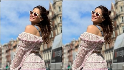 Aamna wore her tresses open with a part into a messy top bun and looked super stylish in drawn eyebrows, contoured cheeks and a shade of pastel pink lipstick. (Instagram/@aamnasharifofficial)
