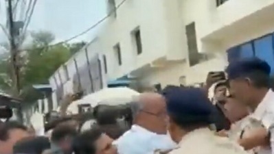 Digvijaya Singh seen holding a police officer's collar (ANI) Digvijaya Singh seen holding a police officer's collar (ANI)