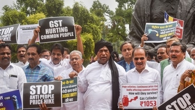 Congress MPs stage a protest near the Gandhi statue over price rise and increase GST on essential commodities during the ongoing Monsoon Session of Parliament. (PTI) Congress MPs stage a protest near the Gandhi statue over price rise and increase GST on essential commodities during the ongoing Monsoon Session of Parliament. (PTI)