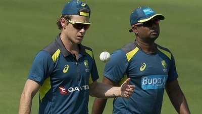 Australia's Adam Zampa, left, walks along with bowling coach Sridharan Sriram during a practice session. (AP)