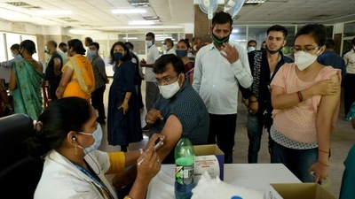 A person being inoculated with a booster dose of Covid-19 vaccine at district hospital Sector 30 , in Noida. (HT Photo) A person being inoculated with a booster dose of Covid-19 vaccine at district hospital Sector 30 , in Noida. (HT Photo)