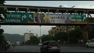 One of the illegal hoardings blocking an important public signage on a foot over bridge along the Sion-Panvel Highway in Navi Mumbai. (BACHCHAN KUMAR/HT PHOTO)