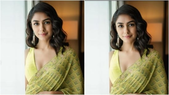 Mrunal teamed the saree with a lemon-yellow sleeveless blouse that featured a plunging neckline.(Instagram/@mrunalthakur)