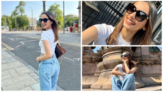 Manushi Chhillar took over the streets of Edinburg, the United Kingdom with her uber casual yet trendy avatar in a basic white crop top, loose-fit ripped denim and black sneakers.(Instagram/@manushi_chhillar)