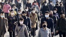 People wearing protective face masks commute amid concerns over the coronavirus disease (COVID-19) in Pyongyang, North Korea.