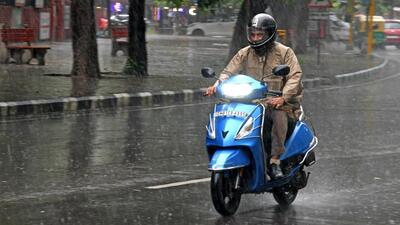 A commuter on his way amid the rain in Chandigarh. (Ravi Kumar/HT)