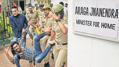 Police personnel detain an ABVP supporter during a protest outside Karnataka home minister Araga Jnanendra in Bengaluru on Saturday (ANI) Police personnel detain an ABVP supporter during a protest outside Karnataka home minister Araga Jnanendra in Bengaluru on Saturday (ANI)