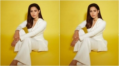 Styled by fashion stylist Nidhi Jeswani, Nushrratt wore her tresses open in soft wavy curls with a side part. (Instagram/@nushrrattbharuccha)