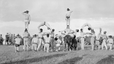 Sports day events were organised to give service personnel a break from their duties. This image features men from the Indian transport unit in a gymnastic display in Salonika Sports Day held in Greece in 1916. (Imperial War Museum)