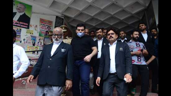 Ali Ahmad (centre with facemask), son of mafiosi-turned-politician and ex-MP Atiq Ahmad after surrendering before the Sessions Court at Prayagraj on Saturday. (HT Photo)