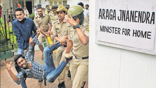 Police personnel detain an ABVP supporter during a protest outside Karnataka home minister Araga Jnanendra in Bengaluru on Saturday (ANI)