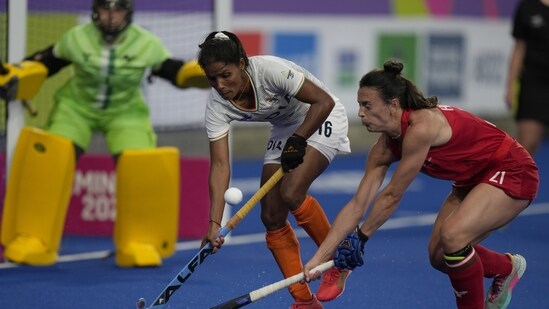 India's Vandana Katariya (16) , left and Wales' Xenna Hughes challenge vie for the ball during the pool A women's hockey match between India and Wales(AP)