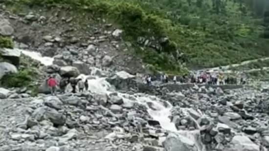 A part of the Badrinath NH-7 washed away due to the rising water in the Khachda drain located at Lambagad. Pilgrims were stranded on both sides of the highway.(ANI)