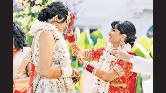 “We wanted to have a big shaadi so LGBTQ people around the world could see that just because you’re Indian and queer doesn’t mean you can’t have a happy future,” says Deepa Kollipara, seen her marrying her partner Gauri Joshi (left). (Apollo Fotografie)
