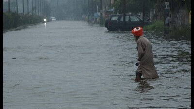 A pedestrian makes his way through knee-deep water after rain lashed Ludhiana on Sunday. (Harvinder Singh/HT) A pedestrian makes his way through knee-deep water after rain lashed Ludhiana on Sunday. (Harvinder Singh/HT)