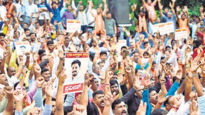 Protesters raised slogans against the BJP government in the state and demanded action against those behind the murder of worker Praveen Nettaru in Dakshina Kannada. (PTI) Protesters raised slogans against the BJP government in the state and demanded action against those behind the murder of worker Praveen Nettaru in Dakshina Kannada. (PTI)