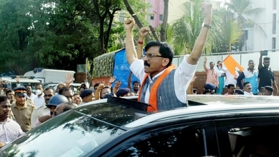 ED officials take the detained Shiv Sena leader Sanjay Raut to the agency office in connection with the alleged Patra Chawl land scam, in Mumbai on Sunday. (ANI Photo) ED officials take the detained Shiv Sena leader Sanjay Raut to the agency office in connection with the alleged Patra Chawl land scam, in Mumbai on Sunday. (ANI Photo)