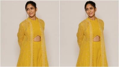 Mrunal decked up in a yellow cropped top with a closed halter neck and midriff-baring details. (Instagram/@mrunalthakur)
