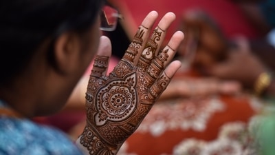 Women apply henna, which is a part of Solah (16) Shringaar, on their hands and feet, wear bright coloured traditional attires and offer prayers. (HT Photo/Sunil Ghosh) Women apply henna, which is a part of Solah (16) Shringaar, on their hands and feet, wear bright coloured traditional attires and offer prayers. (HT Photo/Sunil Ghosh)