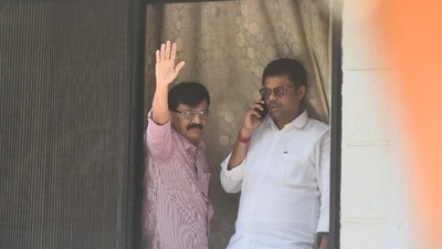 Shiv Sena leader Sanjay Raut waves at supporters as Enforcement Directorate officials conduct searches at his Mumbai residence. (Photo by Satish Bate) Shiv Sena leader Sanjay Raut waves at supporters as Enforcement Directorate officials conduct searches at his Mumbai residence. (Photo by Satish Bate)