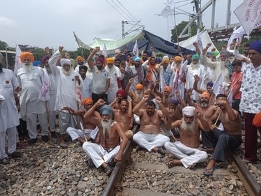 Farmers block the railway track at Vallah in Amritsar on Sunday. (Sameer Sehgal/HT photo) Farmers block the railway track at Vallah in Amritsar on Sunday. (Sameer Sehgal/HT photo)